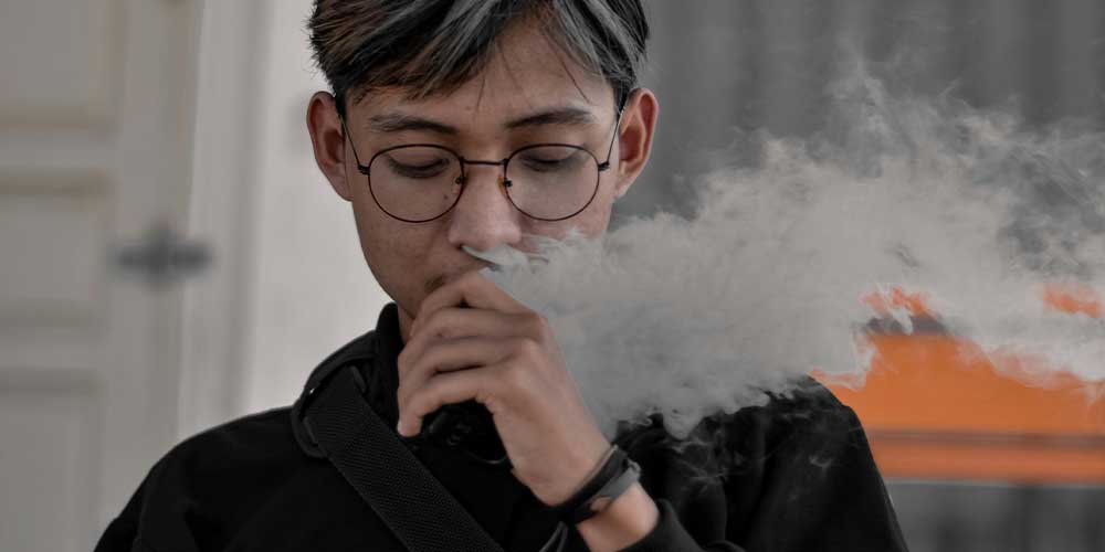 Young Man Vaping Nicotine