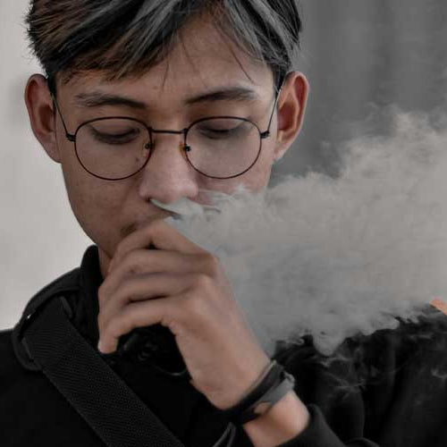 Young Man Vaping Nicotine